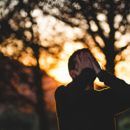 Man holding face with hands