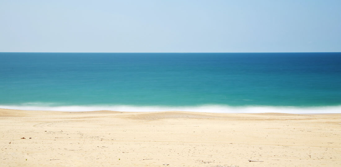 A beach with water in the background