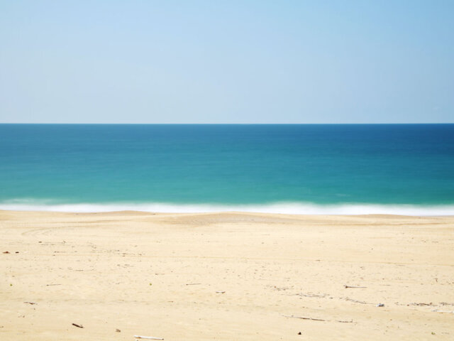 A beach with water in the background