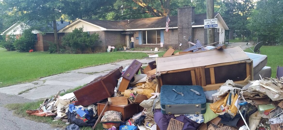 Home with interior debris on front curb