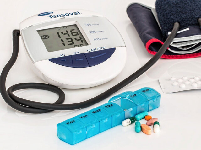 Blood pressure medication in front of a monitor