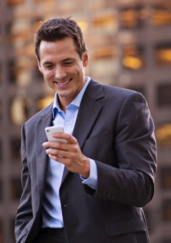 Businessman checks text messages on cell phone