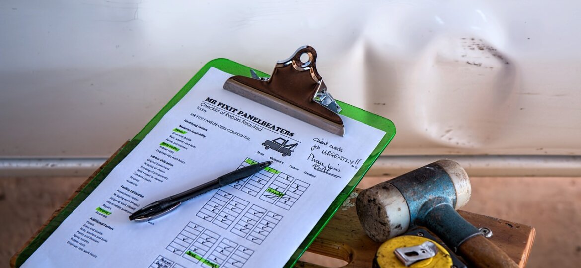 Clipboard with hammer and tape measure