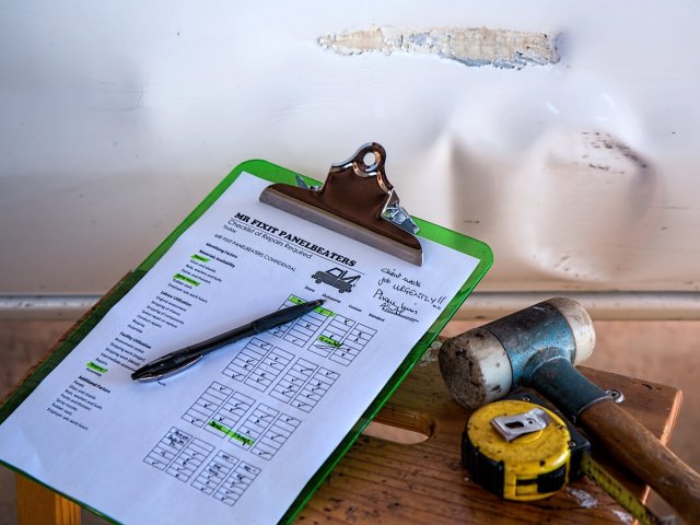 Clipboard with hammer and tape measure