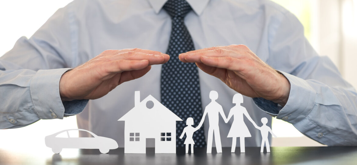 Man with hands over cutout family