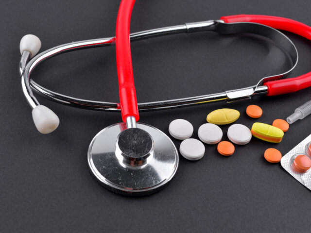 Red stethoscope and medications