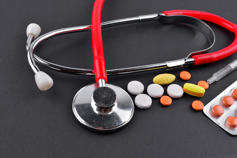 Red stethoscope and medications