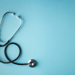 Stethoscope on blue background