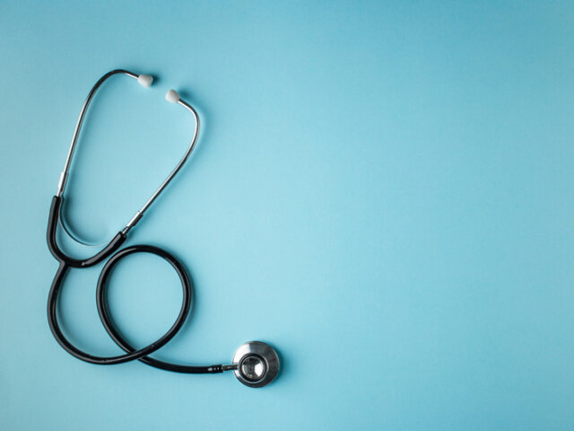 Stethoscope on blue background