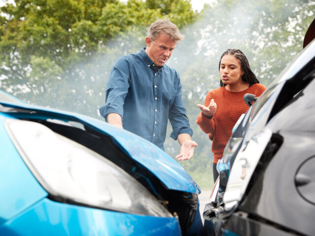 Two Angry Motorists Arguing Over Responsibility For Car Accident