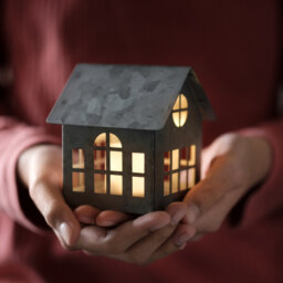 Illuminated home in hands