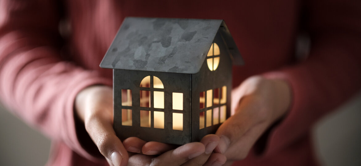 Illuminated home in hands