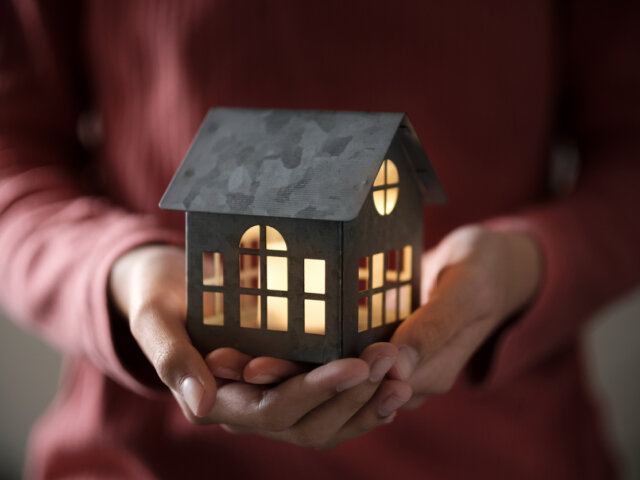 Illuminated home in hands