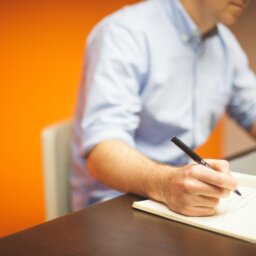 Man at desk with paper and pen