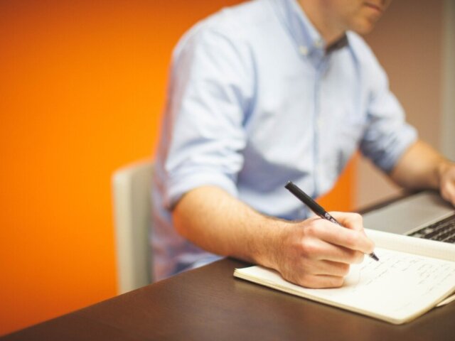 Man at desk with paper and pen