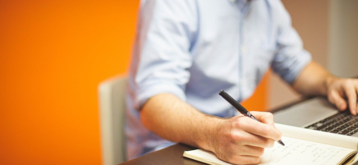 Man at desk with paper and pen