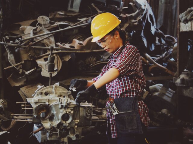 Woman working on engine