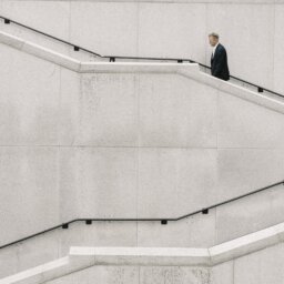 Man climbing white stairs