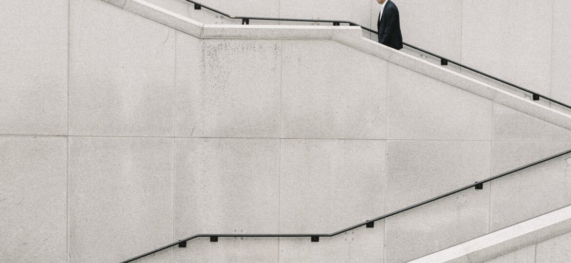 Man climbing white stairs