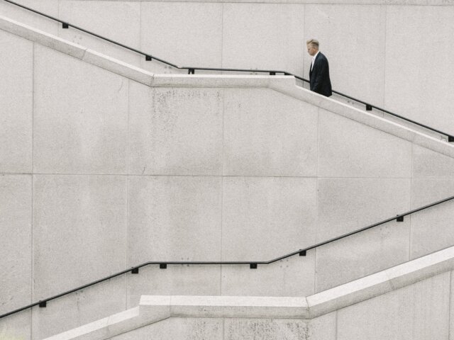 Man climbing white stairs