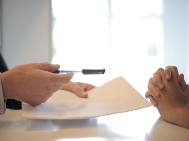 Person with pen and paper