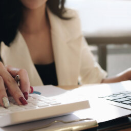 Woman with computer and calculator