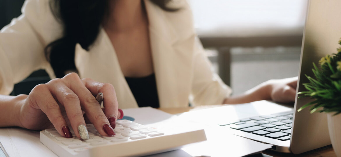 Woman with computer and calculator