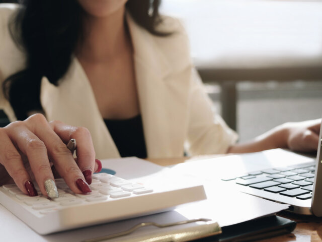 Woman with computer and calculator