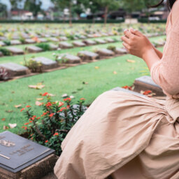 Woman in front of grave