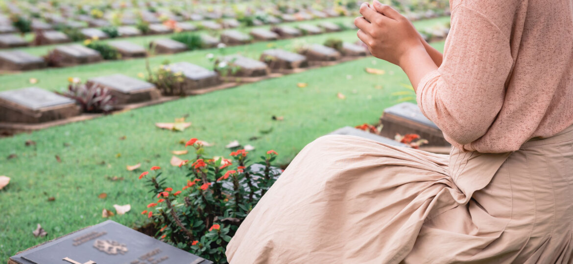 Woman in front of grave