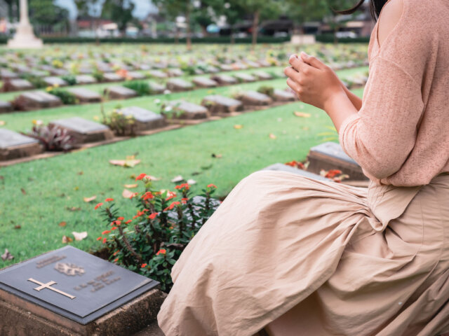 Woman in front of grave