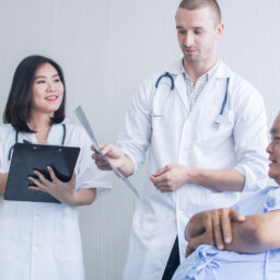 Two doctors talking with patient