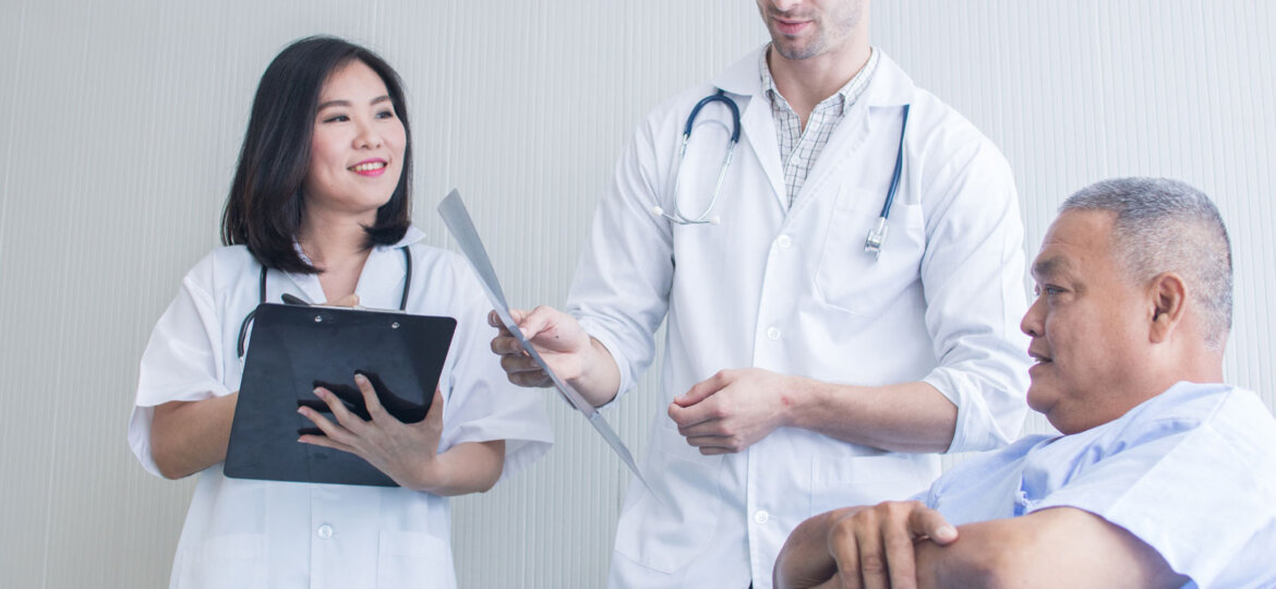 Two doctors talking with patient