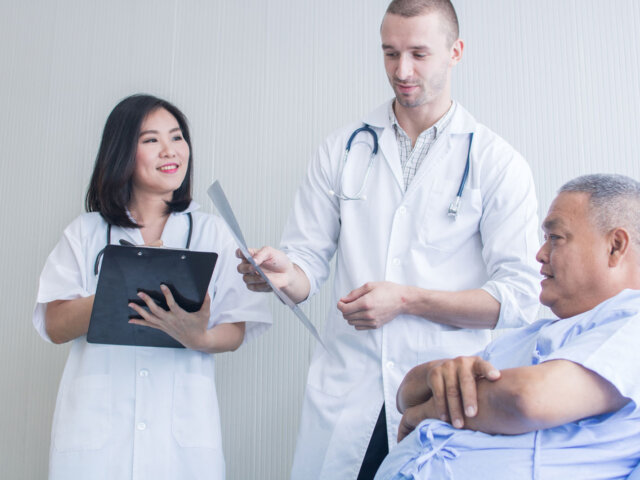 Two doctors talking with patient