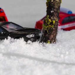 Black toy car in snow