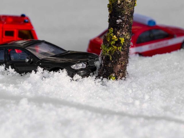 Black toy car in snow